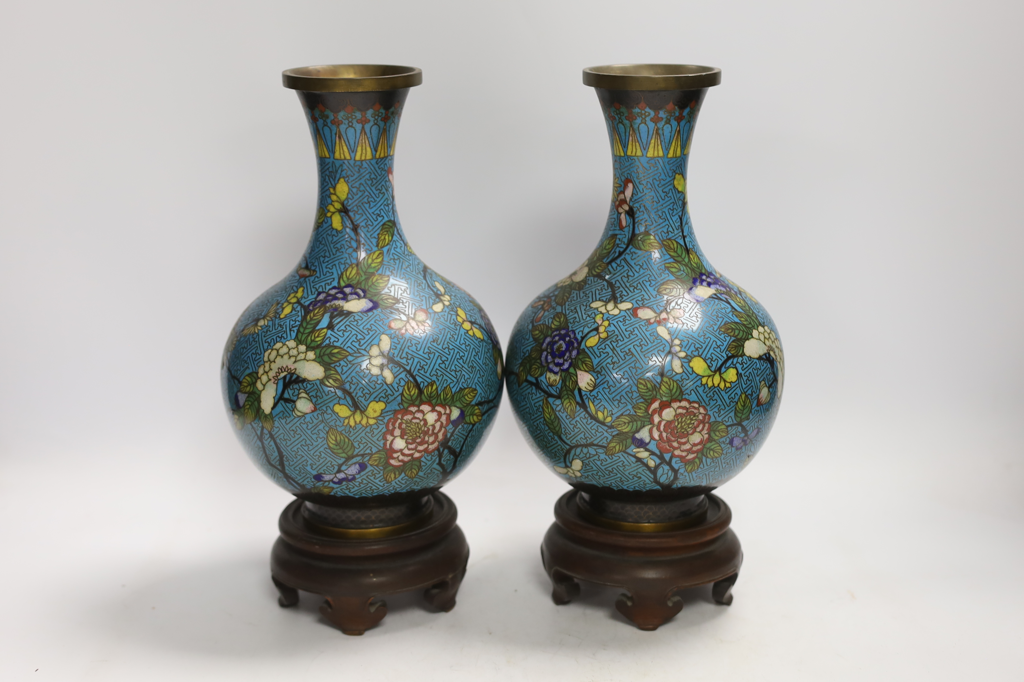 A pair of Chinese cloisonné enamel vases, late Qing dynasty, 31cm, (a.f.), on hardwood stands